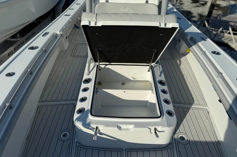 Slide: The Image of 2021 Costa Custom Boats 264 HC deck with open storage compartment. - 11