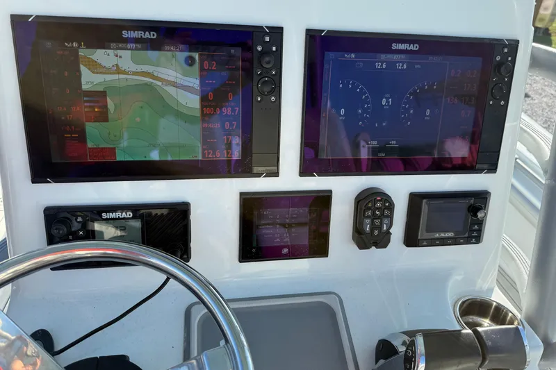 Slide: The Image of Control panel of 2021 Costa Custom Boats 264 HC with Simrad navigation displays. - 15