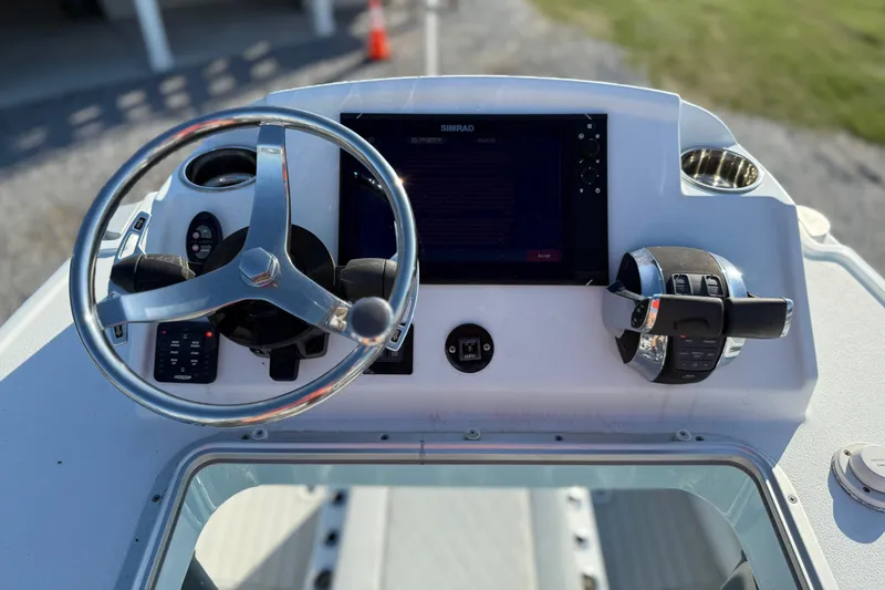 Slide: The Image of Helm of 2021 Costa Custom Boats 264 HC with steering wheel and control panel. - 19