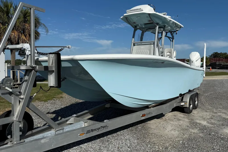 Slide: The Image of 2021 Costa Custom Boats 264 HC on trailer, light blue hull, parked outdoors. - 2