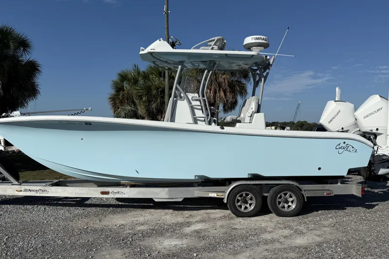 Slide: The Image of 2021 Costa Custom Boats 264 HC on trailer, light blue hull, parked outdoors. - 3