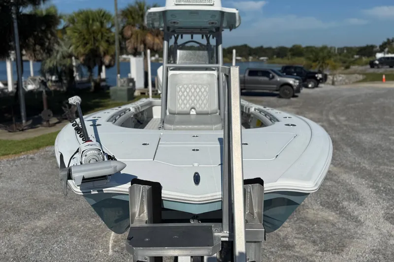 Slide: The Image of 2021 Costa Custom Boats 264 HC on trailer, parked near waterfront with palm trees. - 6