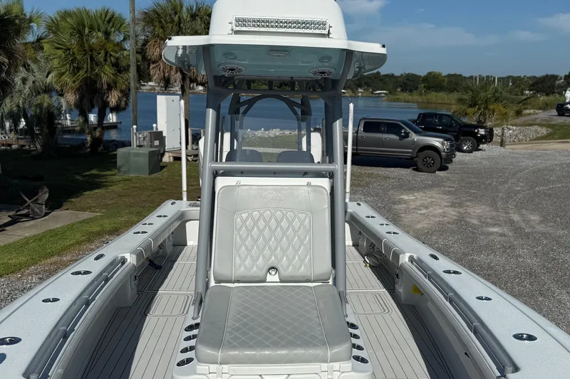 Slide: The Image of 2021 Costa Custom Boats 264 HC on trailer, parked near water with palm trees. - 7