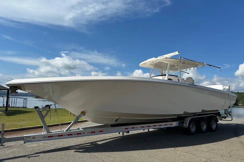 Slide: The Image of 2022 Fountain 38 CC LS boat on trailer under clear blue sky. - 1