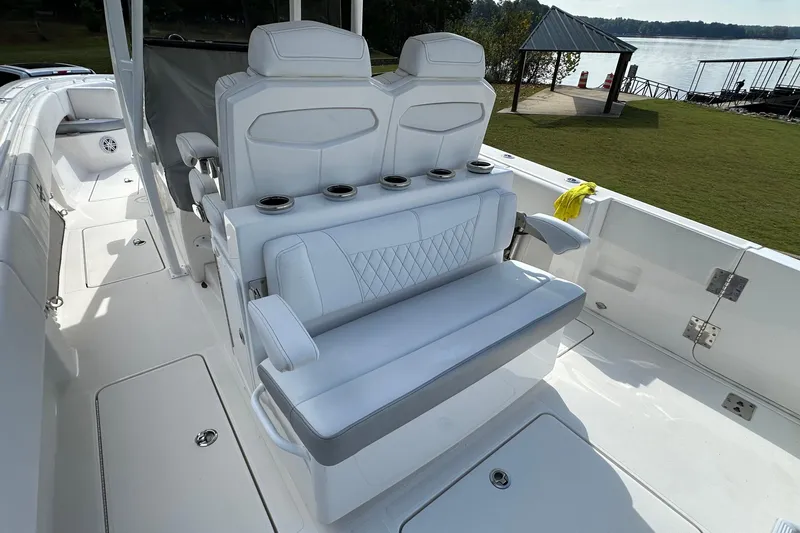 Slide: The Image of 2022 Fountain 38 CC LS boat with luxurious white seating and cup holders. - 18