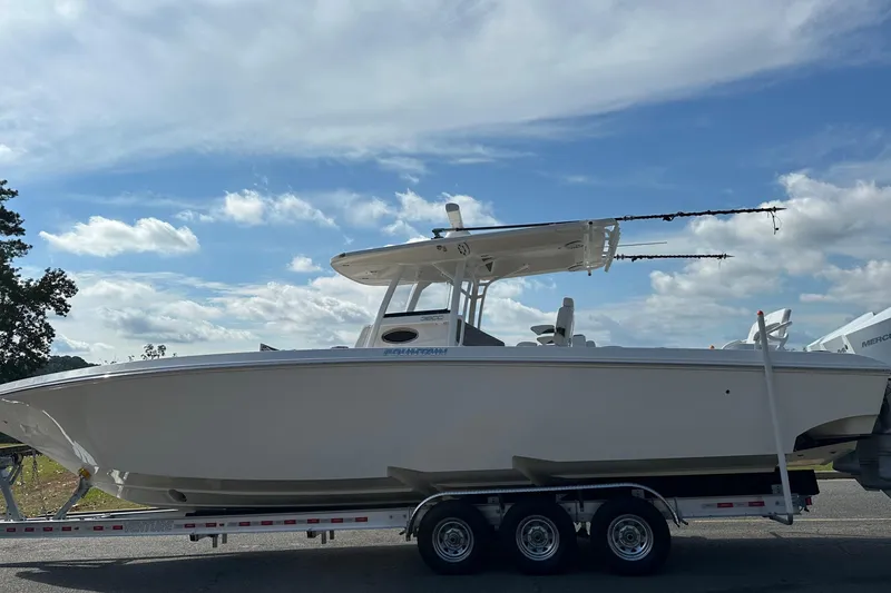 Slide: The Image of 2022 Fountain 38 CC LS boat on trailer under blue sky. - 2