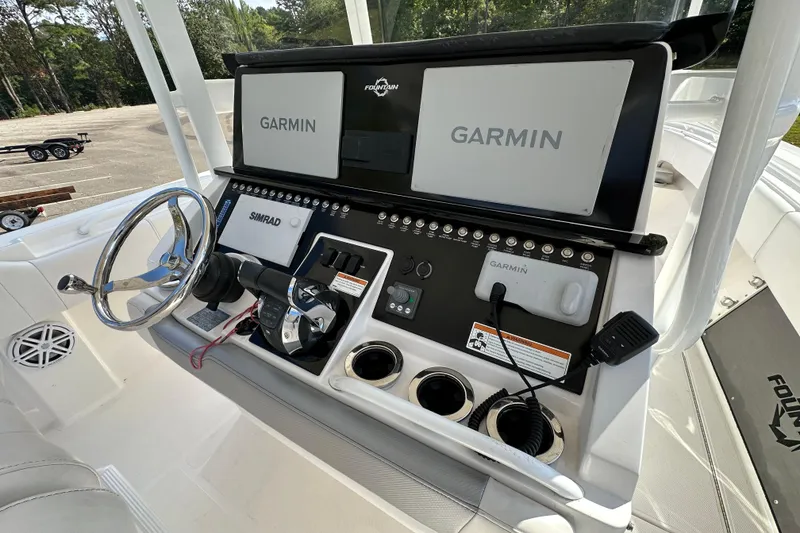 Slide: The Image of 2022 Fountain 38 CC LS boat dashboard with Garmin and Simrad displays. - 20