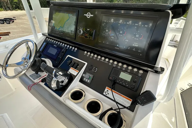 Slide: The Image of 2022 Fountain 38 CC LS boat dashboard with advanced navigation and control systems. - 21