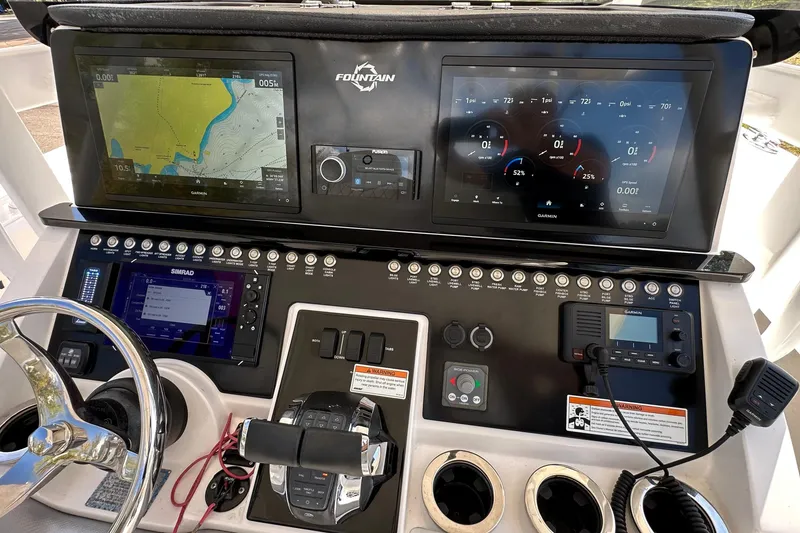 Slide: The Image of 2022 Fountain 38 CC LS boat dashboard with navigation and control systems. - 22