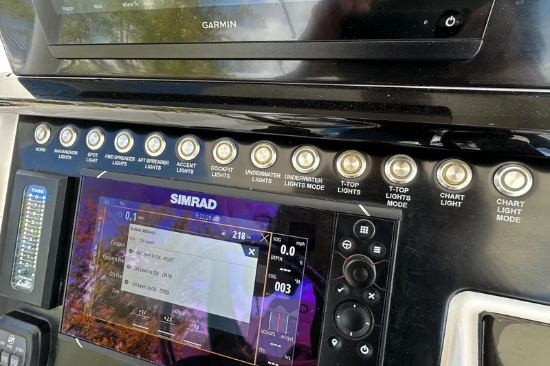 Slide: The Image of Control panel of 2022 Fountain 38 CC LS boat with Simrad and Garmin displays. - 25