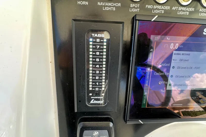 Slide: The Image of Control panel of 2022 Fountain 38 CC LS boat with digital display and tab indicators. - 29