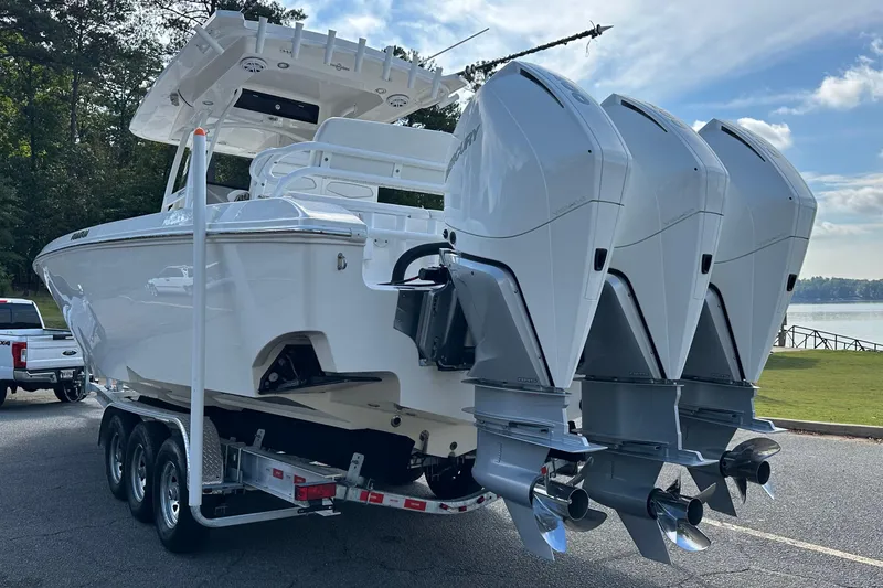 Slide: The Image of 2022 Fountain 38 CC LS boat with triple outboard engines on trailer. - 3