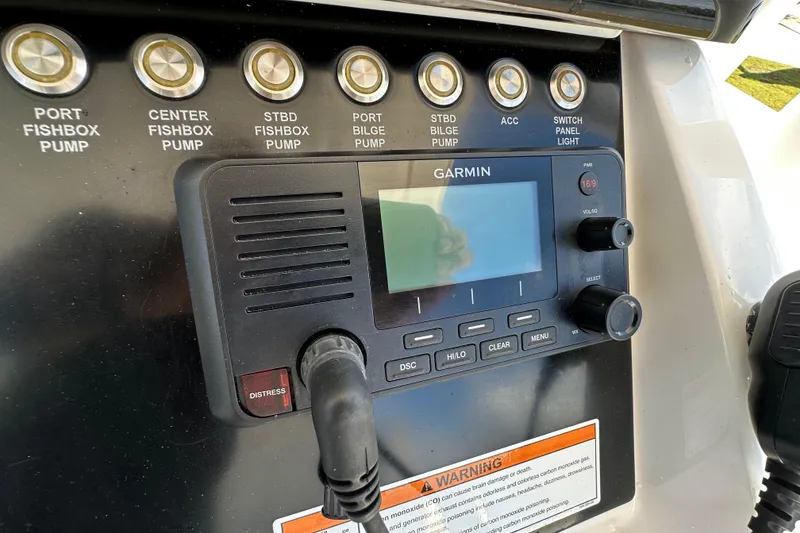 Slide: The Image of Control panel of 2022 Fountain 38 CC LS boat with Garmin display and pump switches. - 32