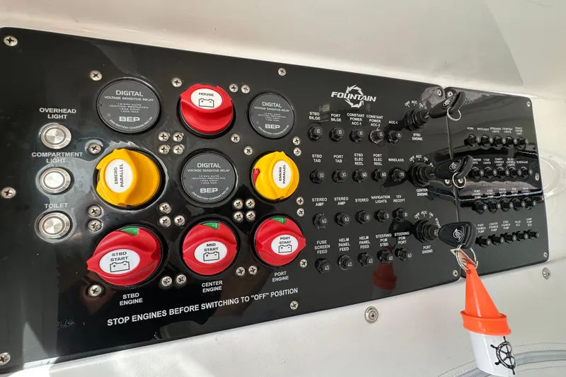 Slide: The Image of Control panel of a 2022 Fountain 38 CC LS boat with various switches and indicators. - 34