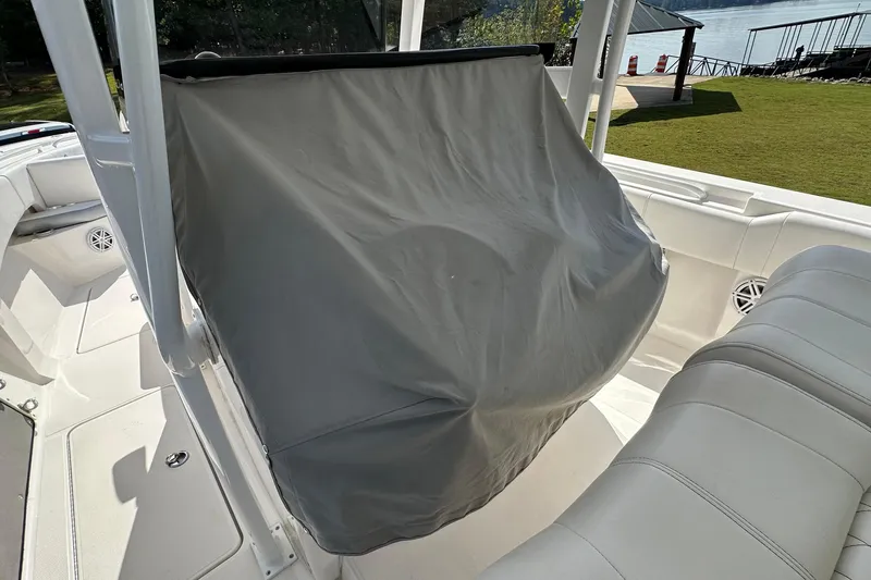 Slide: The Image of 2022 Fountain 38 CC LS boat interior with covered console and seating area. - 39