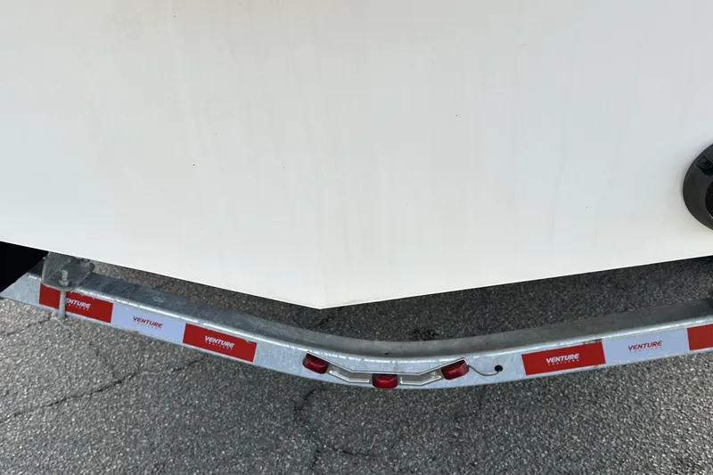 Slide: The Image of Trailer with 2022 Fountain 38 CC LS boat on pavement. - 42