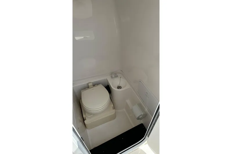 Slide: The Image of 2022 Fountain 38 CC LS boat interior bathroom with toilet and sink. - 45