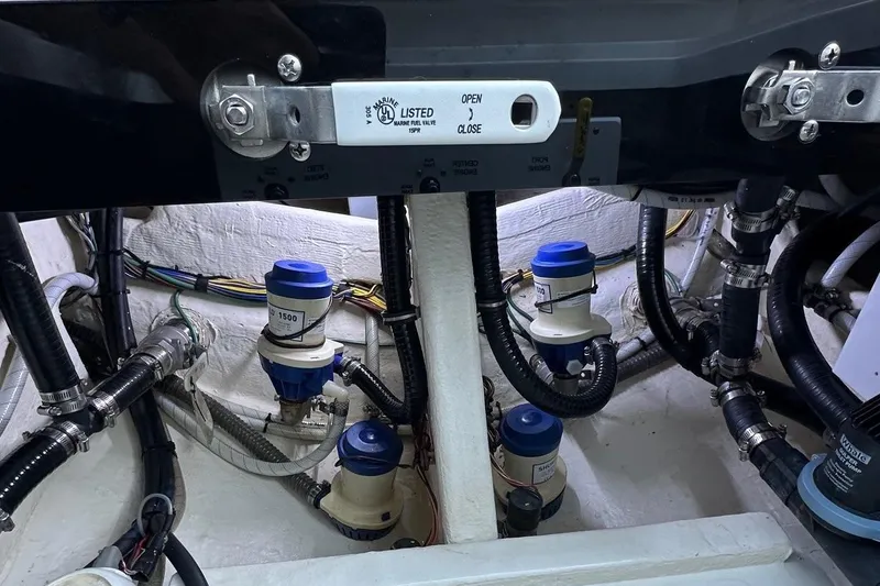 Slide: The Image of Engine compartment of 2022 Fountain 38 CC LS boat with marine valve and hoses. - 46