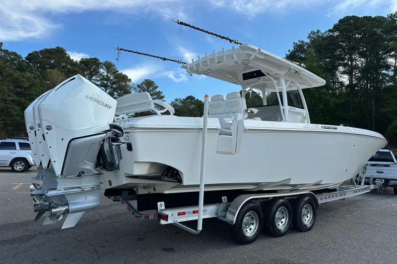 Slide: The Image of 2022 Fountain 38 CC LS boat on trailer with Mercury engines, parked outdoors. - 5