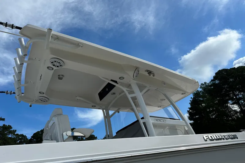 Slide: The Image of 2022 Fountain 38 CC LS boat with T-top against a blue sky. - 61