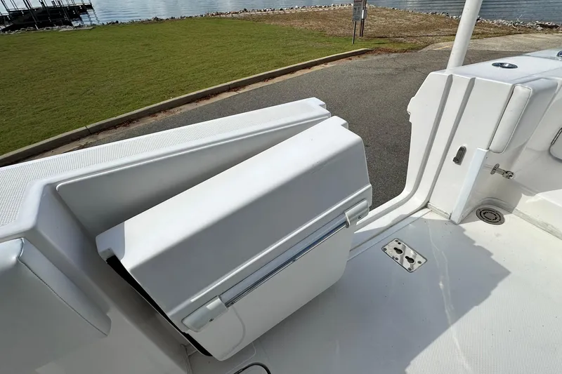 Slide: The Image of 2022 Fountain 38 CC LS boat interior with open storage compartment, near waterfront. - 64