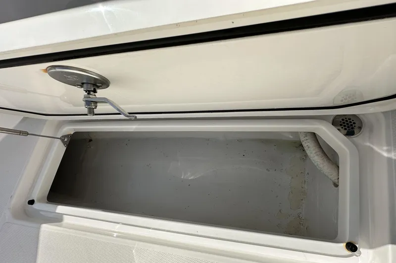 Slide: The Image of Open storage compartment on 2022 Fountain 38 CC LS boat, showing interior details. - 70