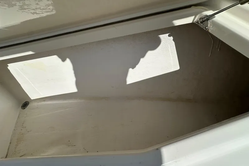 Slide: The Image of Open storage compartment on 2022 Fountain 38 CC LS boat, showing interior space. - 72