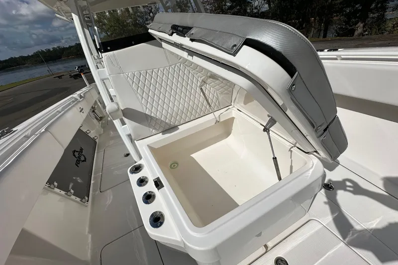 Slide: The Image of 2022 Fountain 38 CC LS boat with open storage compartment and sleek seating design. - 73