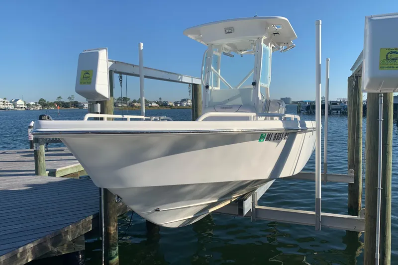 The Image of 2008 Everglades 223 Center Console boat on lift at marina dock. - 1