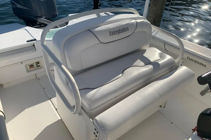 Slide: The Image of 2008 Everglades 223 Center Console boat with white seating and visible engine. - 12
