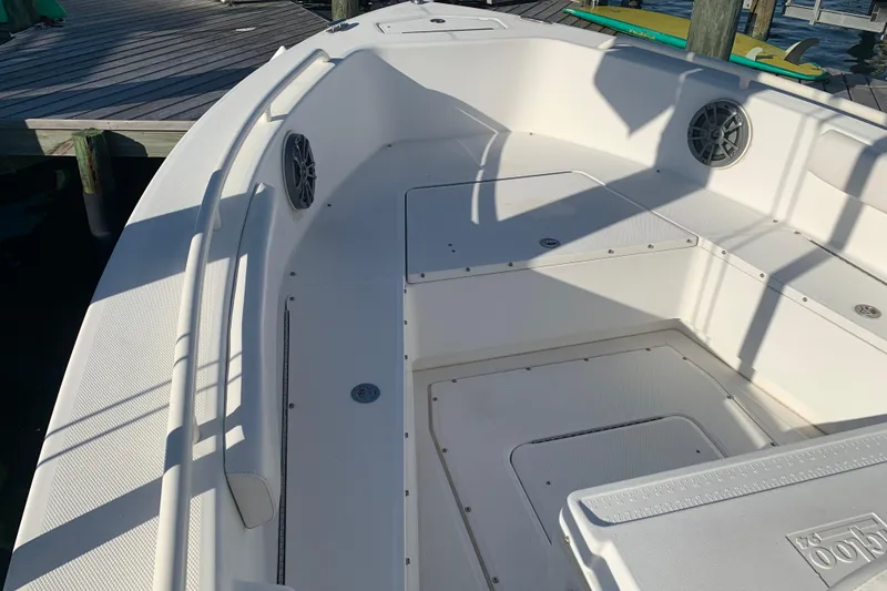 Slide: The Image of 2008 Everglades 223 Center Console boat interior with seating and storage compartments. - 19