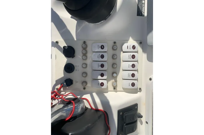 Slide: The Image of Control panel of 2008 Everglades 223 Center Console boat with switches and wiring. - 21