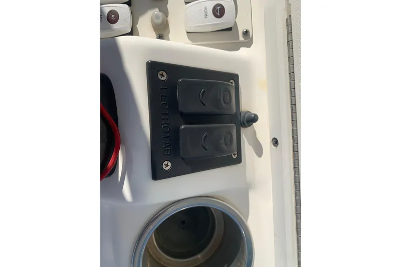 Slide: The Image of Control panel of 2008 Everglades 223 Center Console boat with Lectrotab switches. - 22
