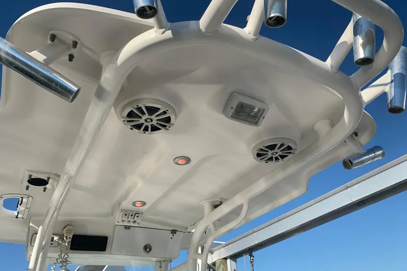 Slide: The Image of 2008 Everglades 223 Center Console boat roof with speakers and rod holders. - 24