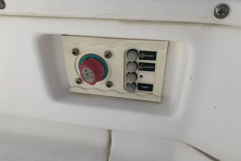 Slide: The Image of Control panel on a 2008 Everglades 223 Center Console boat, featuring switches and a dial. - 26