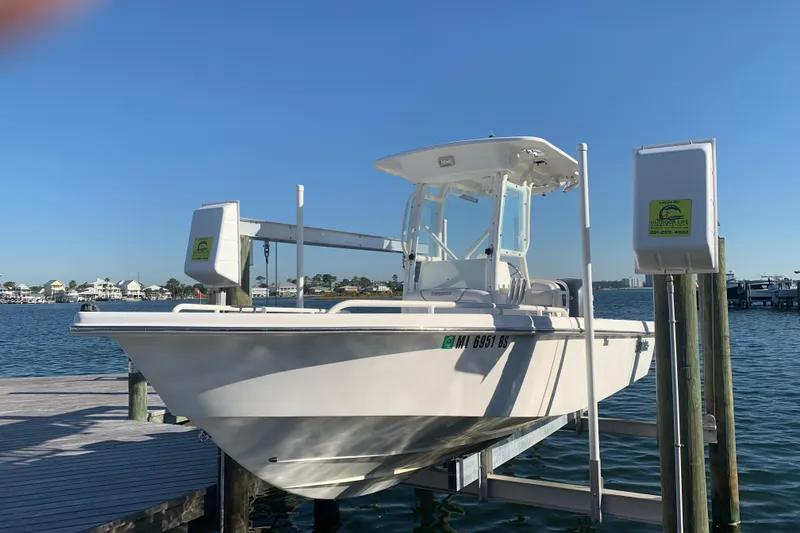 Slide: The Image of 2008 Everglades 223 Center Console boat docked on a sunny day by the water. - 28