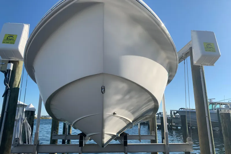 Slide: The Image of 2008 Everglades 223 Center Console boat on lift at marina, clear sky background. - 3