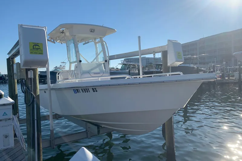 Slide: The Image of 2008 Everglades 223 Center Console boat docked at marina under clear sky. - 4