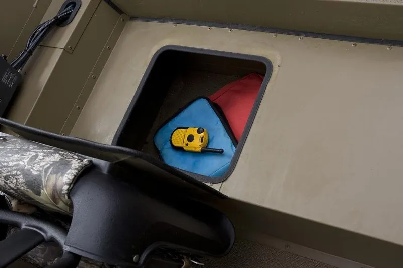 Slide: The Image of Storage compartment in 2026 G3 17SC boat with walkie-talkie and gear. - 3