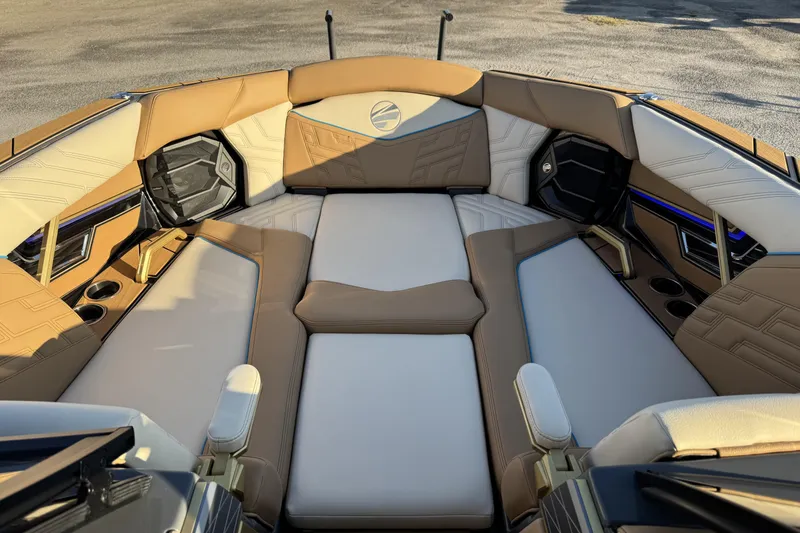Slide: The Image of 2026 Tigé Ultré 25ZX boat interior with luxurious tan and white seating, cup holders, and speakers. - 15