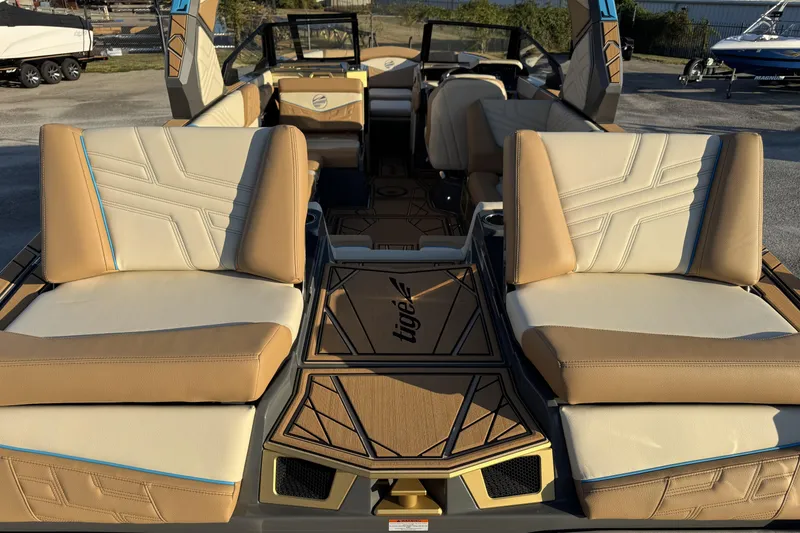 Slide: The Image of 2026 Tigé Ultré 25ZX boat interior with luxurious tan seating and modern design. - 17