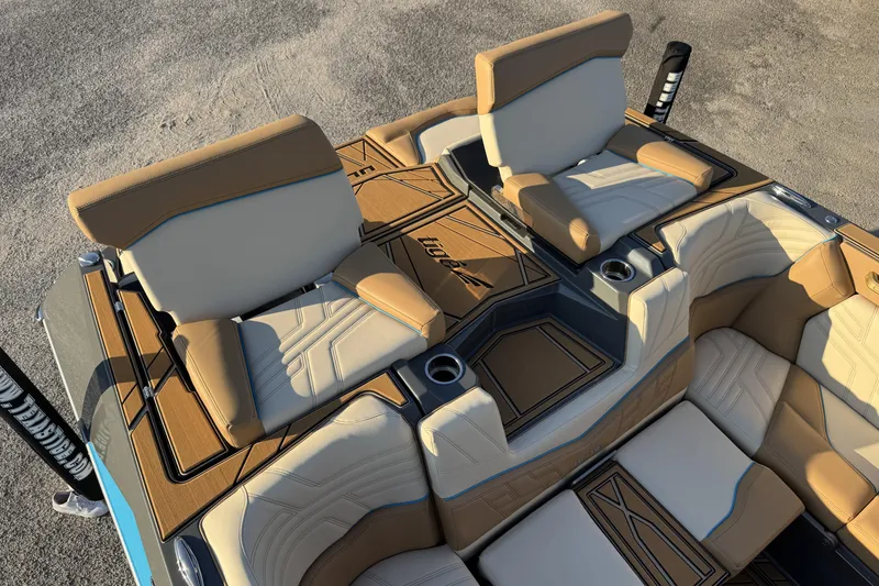 Slide: The Image of 2026 Tigé Ultré 25ZX boat interior with tan and cream seating, cup holders, and stylish design. - 18