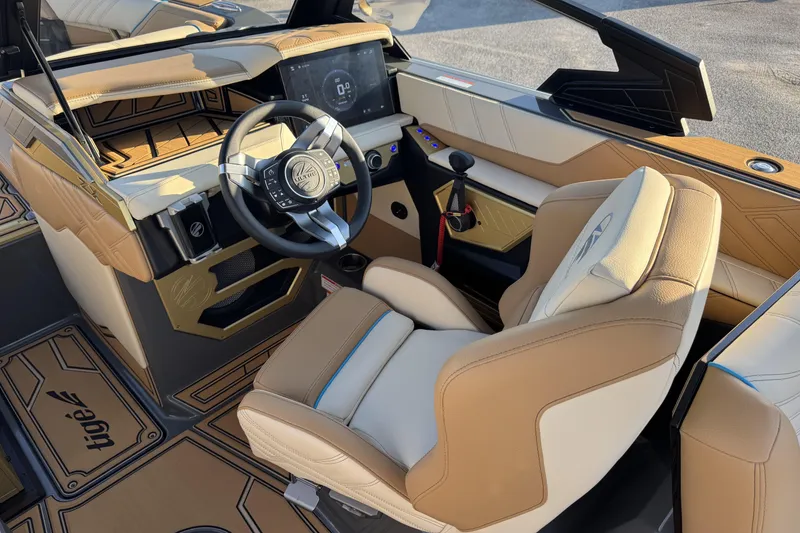 Slide: The Image of 2026 Tigé Ultré 25ZX boat interior with modern dashboard and luxurious seating. - 7
