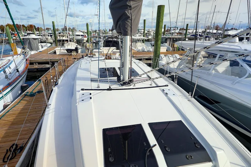 Slide: The Image of 2025 Hanse 458 yacht docked at marina, showcasing sleek deck design and rigging. - 1