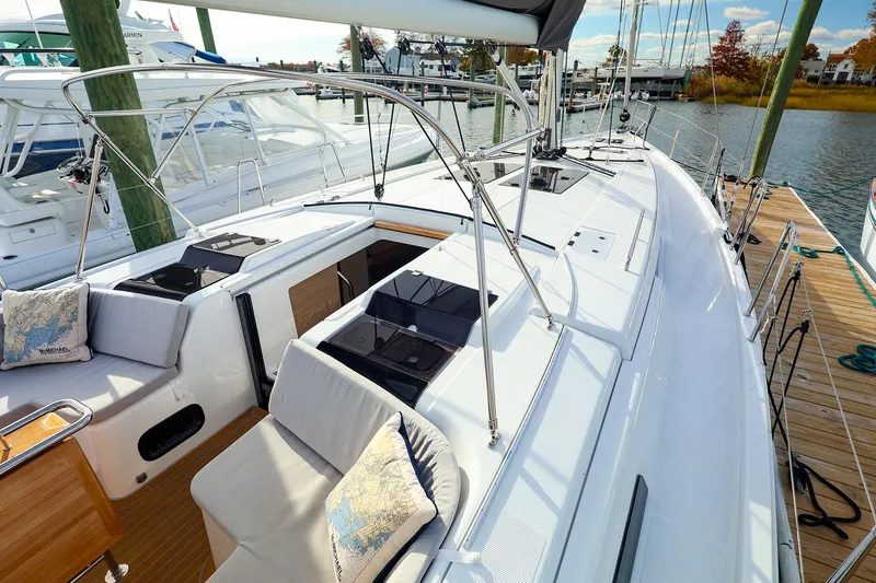 Slide: The Image of 2025 Hanse 458 yacht docked, featuring sleek deck design and comfortable seating. - 11