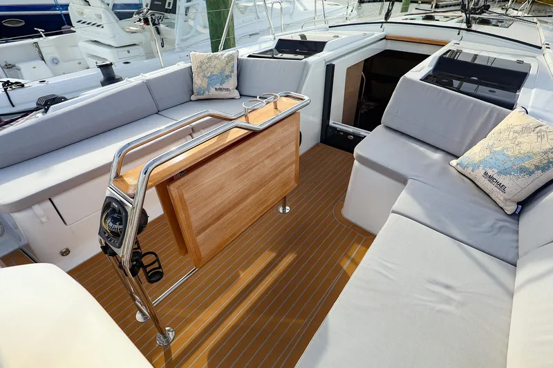 Slide: The Image of Luxurious 2025 Hanse 458 yacht cockpit with comfortable seating and elegant wooden table. - 13