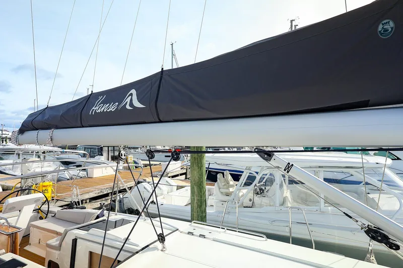 Slide: The Image of 2025 Hanse 458 sailboat with covered boom, docked at marina. - 16