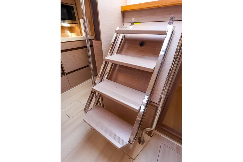 Slide: The Image of Interior stairs of 2025 Hanse 458 yacht, featuring sleek wooden design and modern finish. - 18