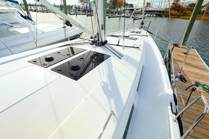 Slide: The Image of 2025 Hanse 458 yacht docked, showcasing sleek deck design and modern features. - 2