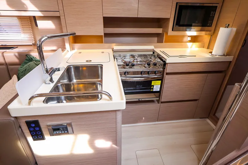 Slide: The Image of Modern kitchen interior of 2025 Hanse 458 yacht with stainless steel sink and appliances. - 24